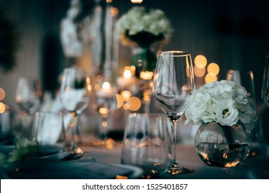 Luxury table settings for fine dining with and glassware, beautiful blurred  background. For events, weddings.  Preparation for holiday dinner night. props for weddings, birthdays, and celeb