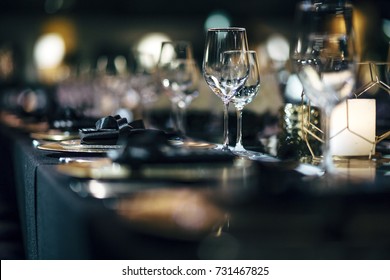 Luxury table settings for fine dining with and glassware, beautiful blurred  background. Preparation for holiday  Christmas and Hannukah dinner night.