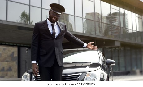 Luxury taxi service driver welcoming very important client near, expensive car