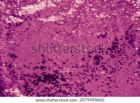 Luxury texture made of violet sequins. Shiny colors 2022