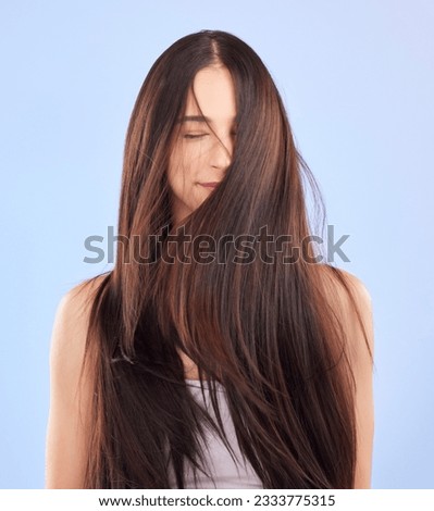 Luxury, texture and woman with hair care, cosmetics and wellness against a blue studio background. Female person, aesthetic and model with volume, wavy and scalp treatment with self care and beauty