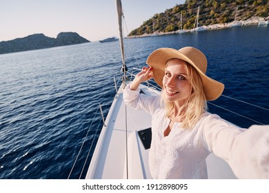 Luxury Travel On The Yacht. Young Happy Woman Taking Selfie On Boat Deck Sailing The Sea. Yachting In Greece.