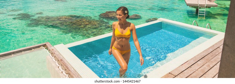 Luxury Travel Vacation At Bora Bora Overwater Bungalow Hotel Honeymoon Suite Room With Infinity Swimming Pool Bikini Woman Enjoying Blue Ocean View. Tropical Summer Lifestyle.