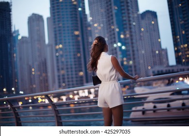 Luxury Travel Vacation Woman. Woman Looking At View. Dubai Marina. (soft Focus)