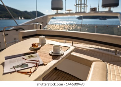 Luxury Traveling. Interior of Modern Motor Yacht,Magazine ,Croissant and Coffee on the Table