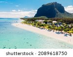 Luxury tropical beach and Le Morne mountain in Mauritius. Beach with palms and ocean. Aerial view