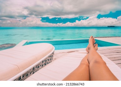 Luxury Vacation Swimming Pool Woman Lounging Relaxing Sun Tanning Legs. Travel Holiday Summer People Lifestyle. POV Selfie Of Feet.