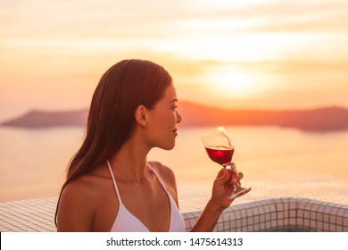 Luxury Vacation Woman Drinking Red Wine Glass In Private Pool At Luxury Hotel Destination. 