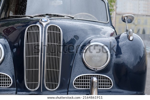 Luxury vintage car 1956 BMW 501 V8 on street it\
downtown Moscow - May, 2021. Old-fashioned blue retro car with\
round headlights, car mirror, windshield, bumper and hood on a\
vintage car.