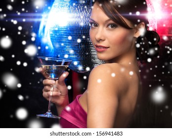 luxury, vip, nightlife, party, christmas, x-mas, new year's eve concept - beautiful woman in evening dress with cocktail and disco ball - Powered by Shutterstock