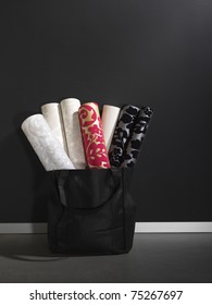 Luxury Wall Paper Rolls Arranged In A Black Basket, Copy Space