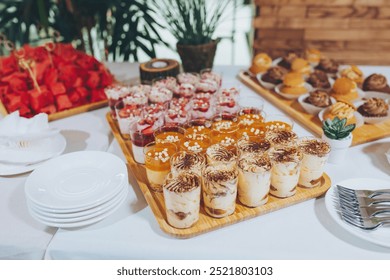 luxury wedding catering, table with modern desserts, cupcakes, sweets with fruits. delicious candy bar at expensive wedding reception. space for text. shower. holiday celebration - Powered by Shutterstock