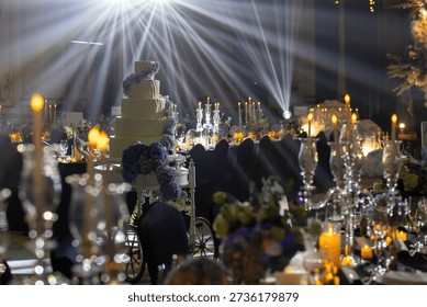 Luxury Wedding Reception with Dramatic Light Rays and Elegant Tiered Cake