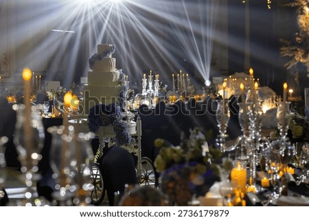 Luxury Wedding Reception with Dramatic Light Rays and Elegant Tiered Cake