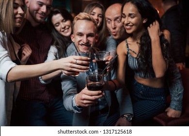 Luxury Whiskey. Group Of Young Friends Smiling And Making A Toast In The Nightclub.