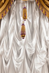 Luxury White Curtains With Golden Fringe And Tassel. Vertical Background Photo