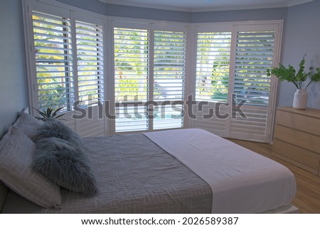 Luxury white indoor plantation shutters in bedroom - selective focus	