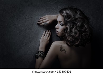 Luxury Woman Hairstyle And Tattoo Portrait Over Dark Background