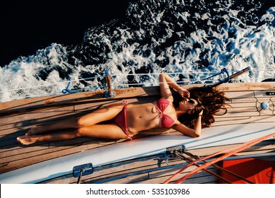 luxury woman yachting in sea. Sea waves background and top view.