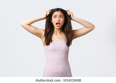 Luxury Women, Party And Holidays Concept. Troubled And Anxious, Panicking Asian Woman Pull Hair Out Of Head Alarmed, Stare Upper Left Corner Shocked, Dont Have Time, Feeling Nervous