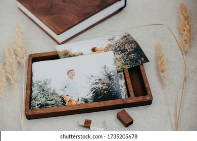 Luxury Wooden Photo Book, Wooden Box With Summer Photos Printed And Flash Card On Linen Natural Background. Family Memories Photobook. Save Your Summer Vacation Memories. Photo Album With Wooden Cover