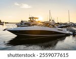 Luxury yacht in the evening sunset. Yacht club marina. Summer vacation. Downtown city marina with luxury yacht. Docked vessels. Luxury yacht in sunset marina