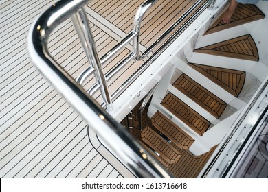 luxury yacht exterior: Wooden deck and steps flooring.