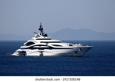 Luxury Yacht With Helipad And Helicopter Sailing In A Sea, Side View. White Futuristic Boat On Mountain Island Background