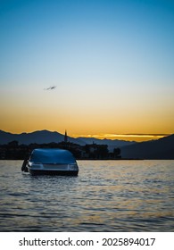 Luxury Yacht Parked On A Lake In Northern Italy, Holiday Boat Ride At Sunrise, Sky Colors At Sunrise