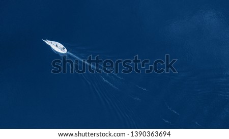 Similar – Aerial view of small boat in sea, copyspace for text