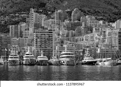Luxury yachts in the harbor and luxury apartment houses in Monaco. One of the smallest states in the world, located in Europe, where you can find luxury cars, homes, apartments and enjoy your money.