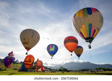 Luye Highlands, Taitung County, Taiwan -  July 24th, 2020 : Hot Air Balloons In Flight And Being Inflated, Paragliders In Between