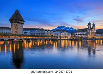 Luzern Kappelbrucke bridge and Jesuten church with Pilatus mountain at background in the evening view, Switzerland