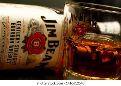 Lviv/ Ukraine, 04.12.2013 :Jim Beam Bottle and a glass  of whiskey (bourbon, liqueur, cognac, alcohol, drink) at close range without people