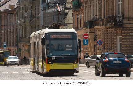 Lviv, Ukraine - 6.14.2021: Tram Goes In The City Downtown Of Lviv, Ukraine. Yellow Tram Moving By The Road. Public Electric Transport Concept. Urban Transportation. Road Traffic In Lviv, Ukraine