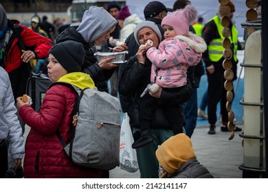 LVIV, UKRAINE - APR 02, 2022: Volunteers in tent camp of World Central Kitchen and Red Cross helping to feed and aid thousands of refugees flee war-torn territories to Europe at Lviv Railway Station.