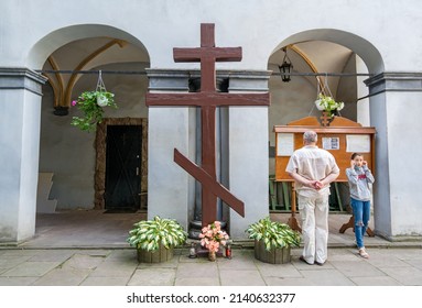 LVIV, UKRAINE - August 19, 2021: A Wooden Three-barred Cross, A Symbol Of The Russian Orthodox Church, In Front Of A Small Chapel.