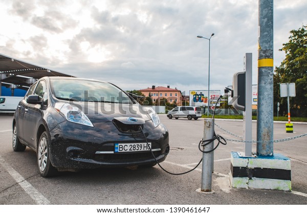 LVIV, UKRAINE - August 28, 2018:
electric car charging at mall parking aria. pure clean
energy
