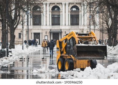 LVIV, UKRAINE - FEBRUARY 10, 2021: HYUNDAI Skid Steer Loader Removes Snow Near The Lviv Theatre Of Opera And Ballet, Lviv Opera House, Winter Time.