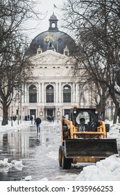 LVIV, UKRAINE - FEBRUARY 10, 2021: HYUNDAI Skid Steer Loader Removes Snow Near The Lviv Theatre Of Opera And Ballet, Lviv Opera House, Winter Time.