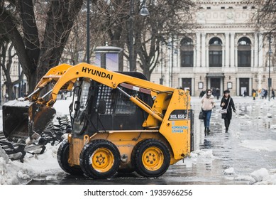 LVIV, UKRAINE - FEBRUARY 10, 2021: HYUNDAI Skid Steer Loader Removes Snow Near The Lviv Theatre Of Opera And Ballet, Lviv Opera House, Winter Time.