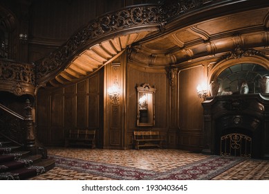 LVIV, UKRAINE - FEBRUARY 13, 2021: The building of the former noble casino, now the House of Scientists. Interior of the magnificent mansion with ornate grand wooden staircase and fireplace.
