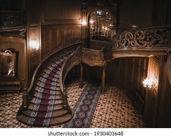 LVIV, UKRAINE - FEBRUARY 13, 2021: The building of the former noble casino, now the House of Scientists. Interior of the magnificent mansion with ornate grand wooden staircase in the great hall.