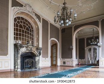 LVIV, UKRAINE - FEBRUARY 13, 2021: The building of the former noble casino, now the House of Scientists. White Room with marble fireplace and chandeliers.