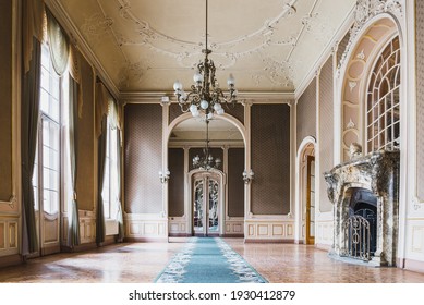 LVIV, UKRAINE - FEBRUARY 13, 2021: The building of the former noble casino, now the House of Scientists. White Room with marble fireplace and chandeliers.