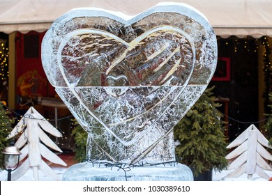 LVIV, UKRAINE - February 21, 2018. Ice Sculpture With A Heart. Hand Hold Heart