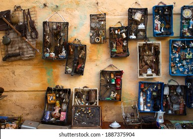 Lviv, Ukraine - January 02, 2021. Aged Wall With Different Antiques On Flea Market Vernisazh With Old Dolls, Toys And Vintage Things. Collectibles Memorabilia And Garage Sale Concept