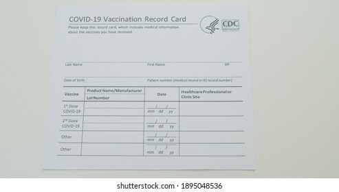 Lviv, Ukraine - January 14, 2021: COVID-19 Vaccination Record Card Tracks Dose Of Coronavirus Vaccine. CDC And Dept. Of Defense Immunization Document.