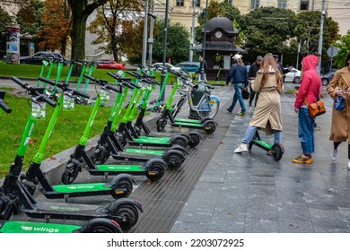 Lviv. Ukraine. July, 2021.Trendy Fashinable Teenager Girls Riding Public Rental Electric Scooters In Urban City Environment. New Eco-friendly Modern Public City Transport