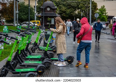 Lviv. Ukraine. July, 2021.Trendy Fashinable Teenager Girls Riding Public Rental Electric Scooters In Urban City Environment. New Eco-friendly Modern Public City Transport